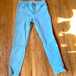 Light teal jeans with distressed cuffs.
